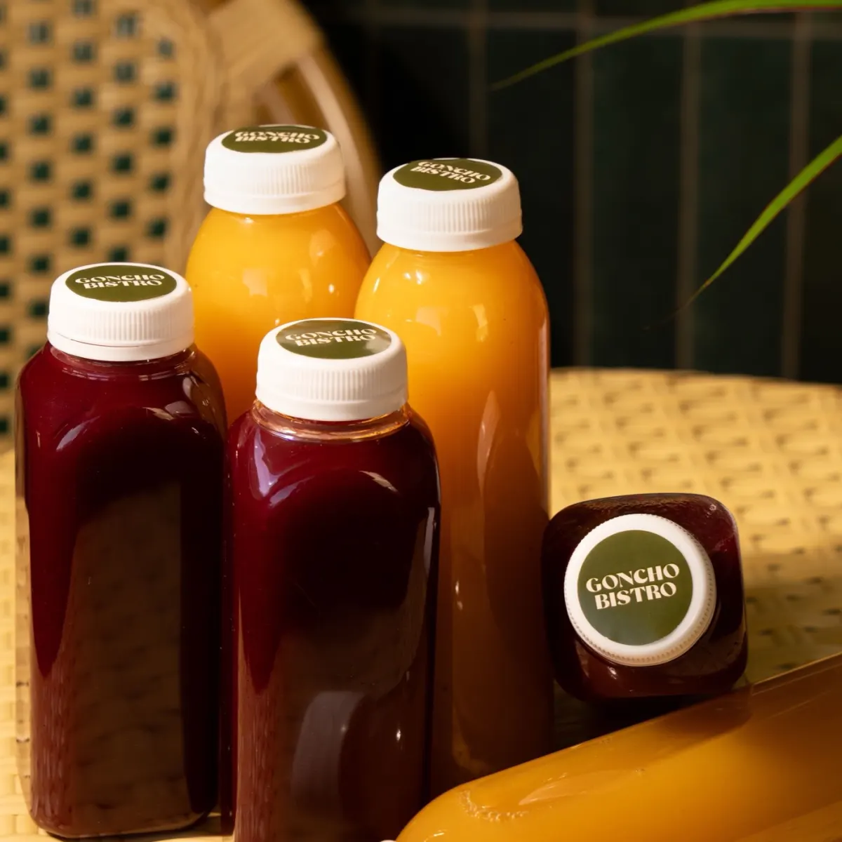 Bottles of house-made berry lemonade with GONCHO BISTRO caps