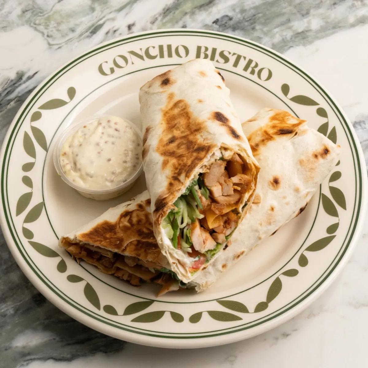 Toasted chicken wrap halves with house dip