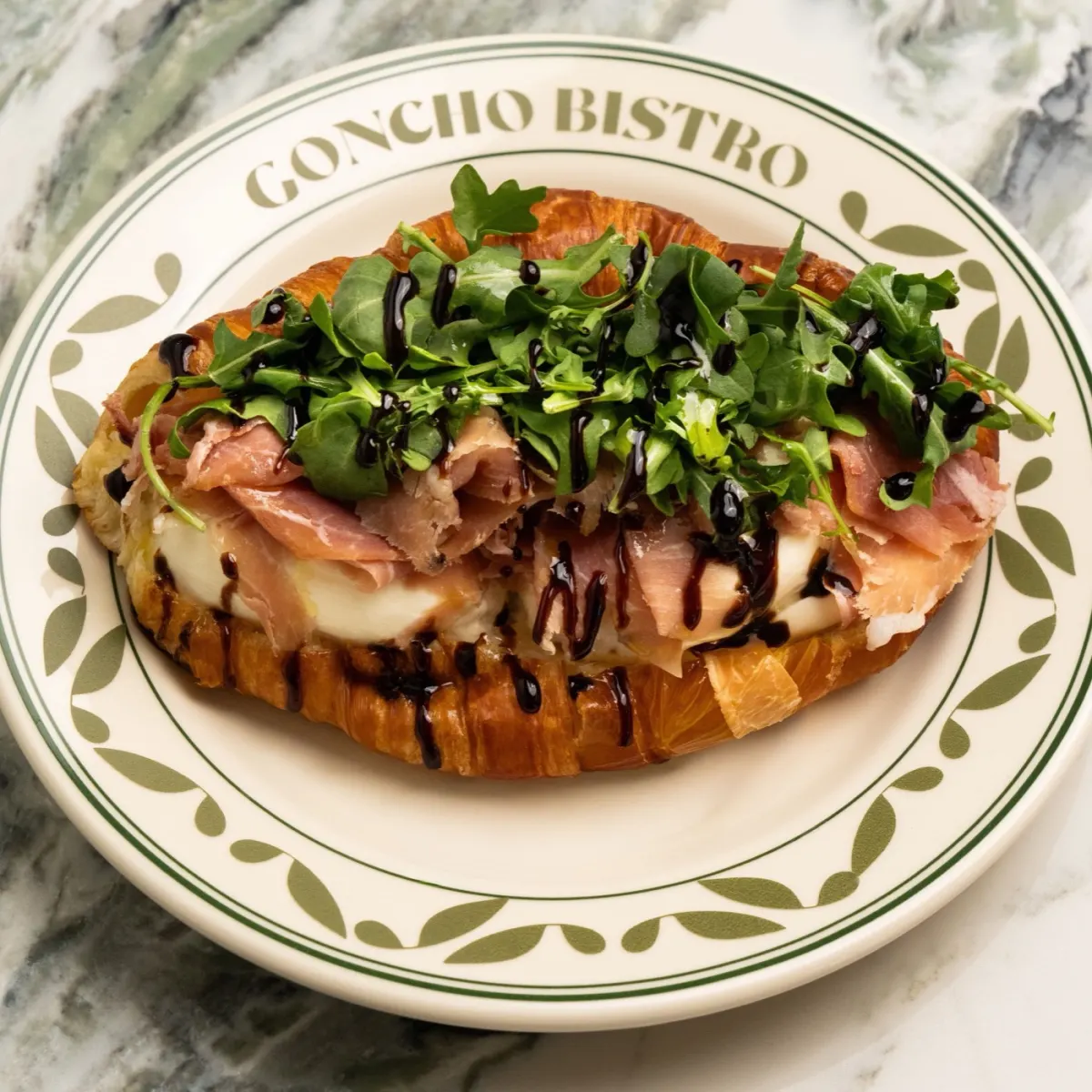 Fig jam and prosciutto croissant with burrata and arugula