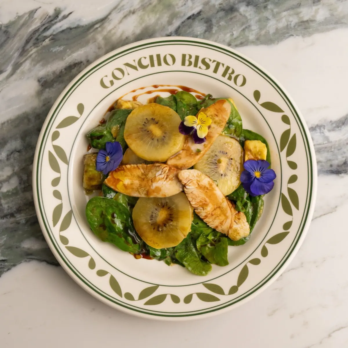 Kiwi and chicken salad bowl with avocado and spinach