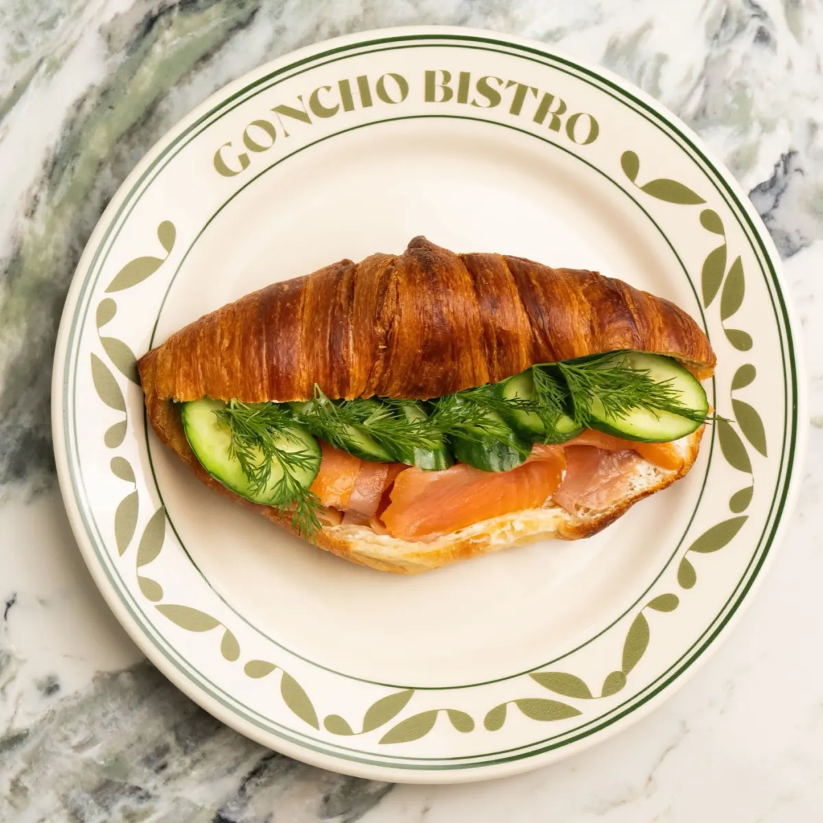 Smoked salmon croissant with avocado cream and dill