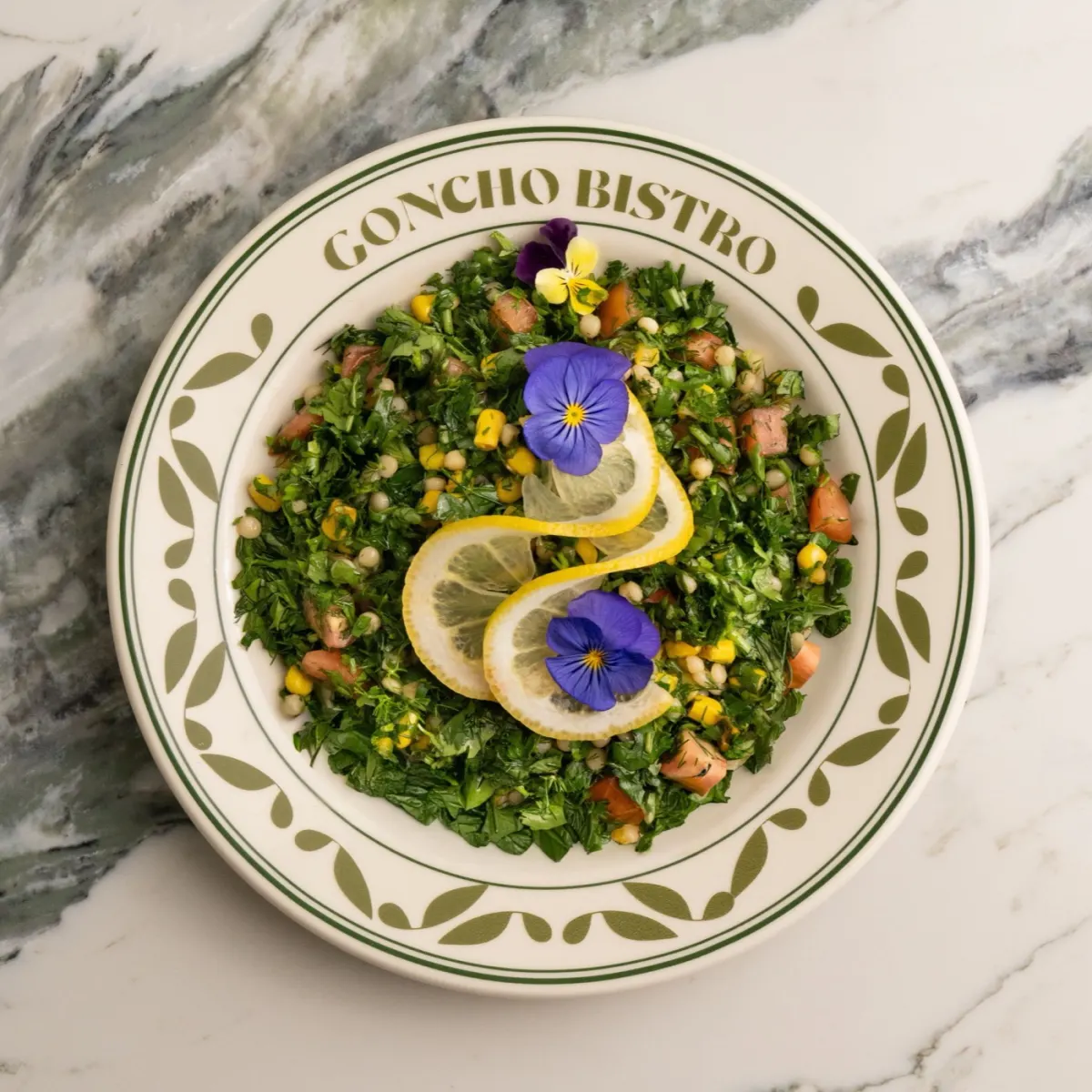 Tabbouleh salad bowl with couscous and herbs
