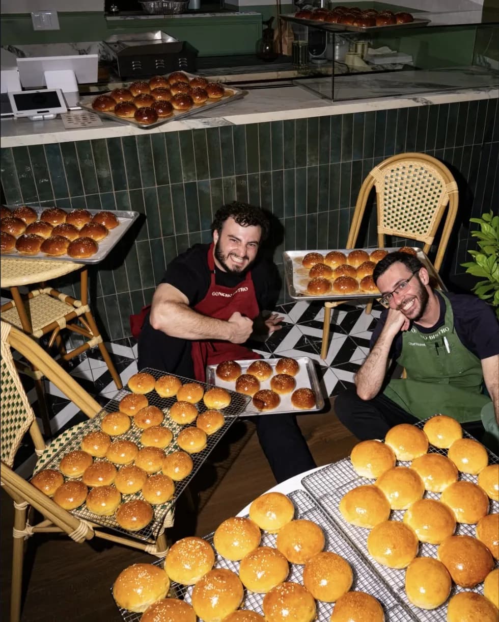 GONCHO BISTRO bakers with trays of freshly baked brioche buns