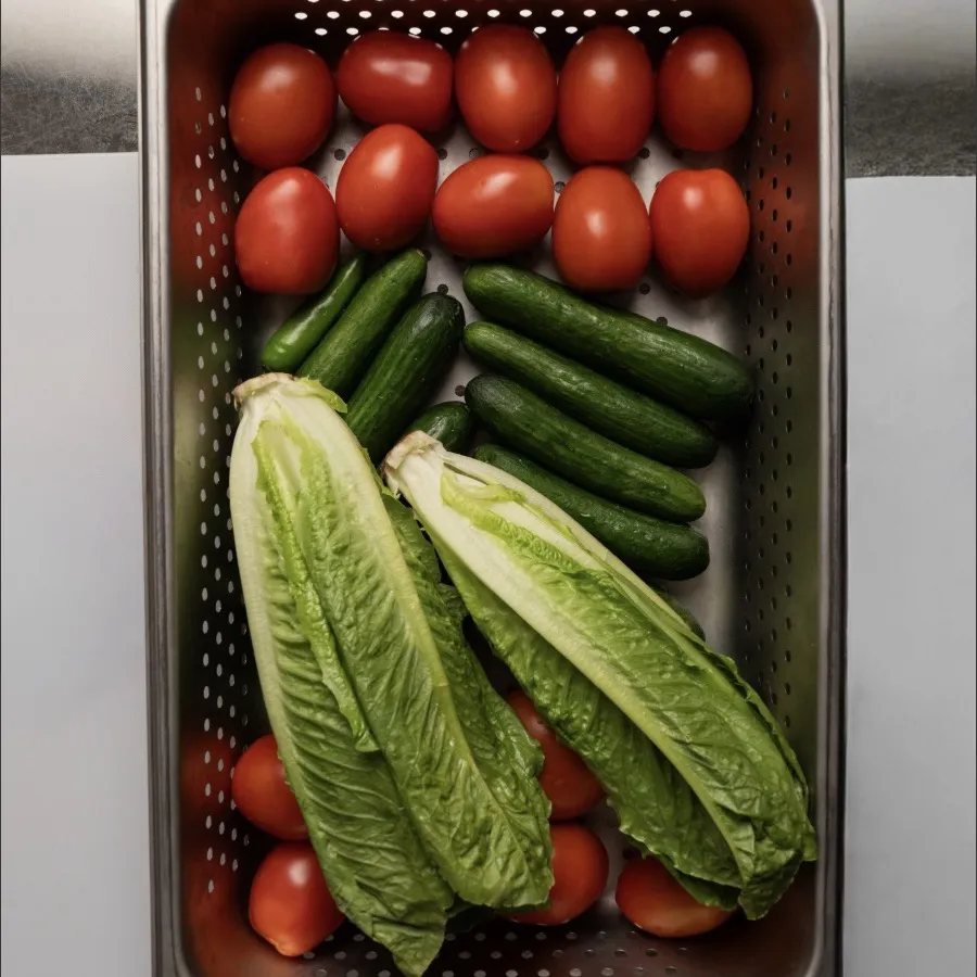 Fresh romaine, cucumbers and tomatoes in the GONCHO BISTRO kitchen